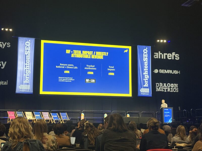 Conference slide explaining the Revenue Influence Factor with £80k return users, £100k tracked attribution and £180k total impact, giving an RIF of 1.8x.