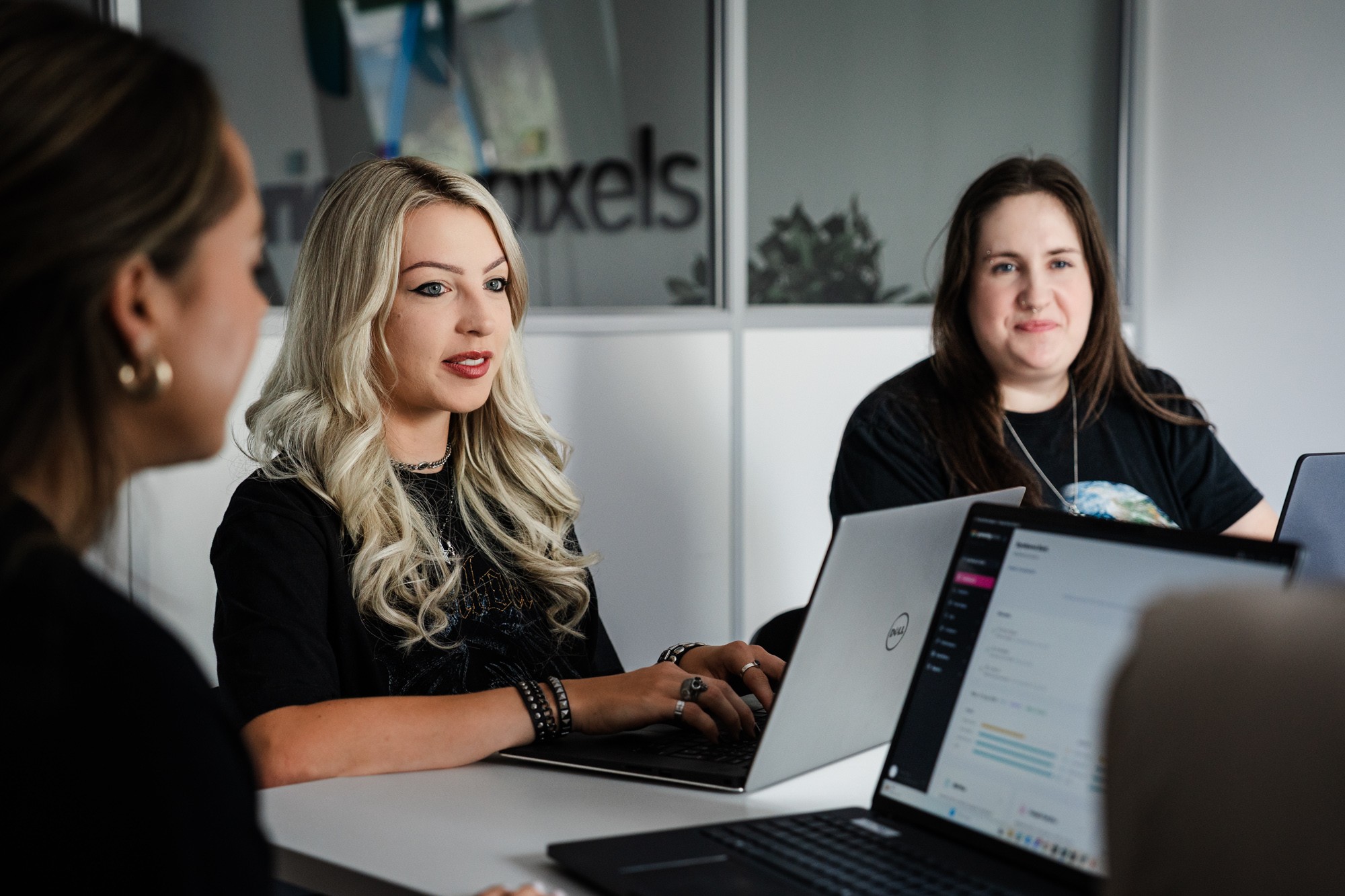 Priority Pixels team member working on SEO in a client meeting